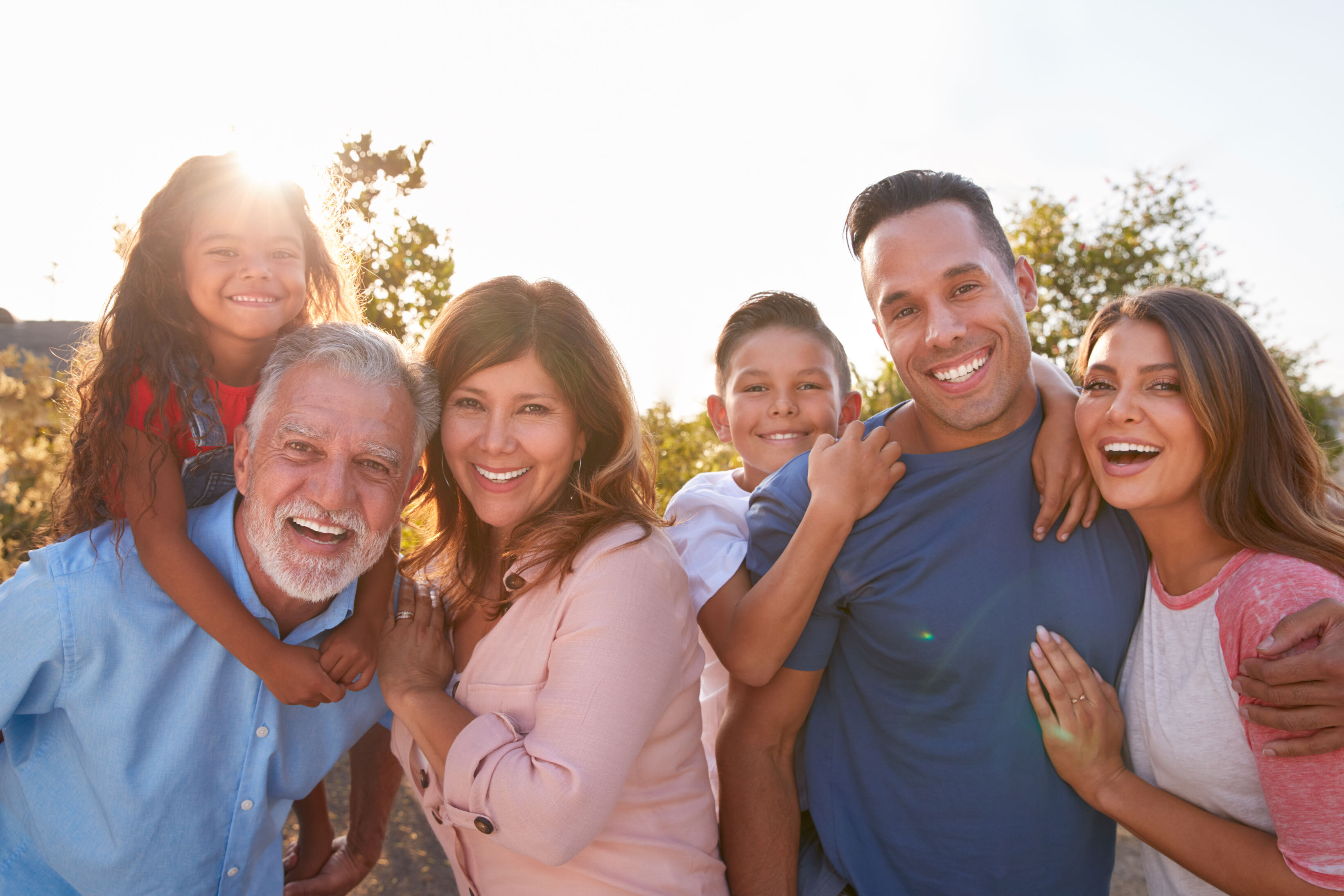 A family posing for a photo together in the sun